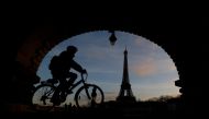 A man rides a bicycle along a bike path on the Pont de Bir-Hakeim bridge near the Eiffel Tower in Paris during a nationwide day of strike and protests against French government's pension reform plan in France, January 19, 2023. (REUTERS/Gonzalo Fuentes)