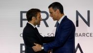 Spain's Prime Minister Pedro Sanchez (right) and France's President Emmanuel Macron shake hands at the end of a press conference after signing a treaty during a Franco-Spanish summit in Barcelona on January 19, 2023.  (Photo by Ludovic MARIN / AFP)