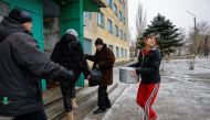 People, including civilians evacuated from the salt-mining town of Soledar in the course of Russia-Ukraine conflict, enter a temporary accommodation centre located in a local dormitory in Shakhtarsk (Shakhtyorsk) in the Donetsk Region, Russian-controlled Ukraine, January 14, 2023. REUTERS/Alexander Ermochenko
