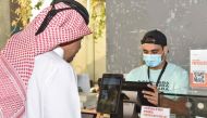 An official of the QNB Group launches the facial payments solution.