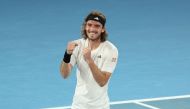 Greece's Stefanos Tsitsipas celebrates after victory against Italy's Jannik Sinner during their men's singles match on day seven of the Australian Open tennis tournament in Melbourne on January 22, 2023. (Photo by Martin KEEP / AFP) 