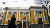 A woman walks past the Estonian embassy in Moscow on January 23, 2023. - Moscow on January 23 downgraded diplomatic relations with Estonia and ordered its ambassador to leave Russia, accusing the Baltic country of 