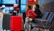 People wait with their luggages during a general strike by employees over pay demands, at the Berlin Brandenburg Airport (BER), in Schoenefeld near Berlin, Germany January 25, 2023. REUTERS/Michele Tantussi