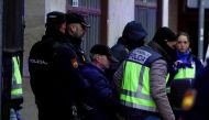 Spanish national police officers lead away a 74-year-old man under arrest on suspicion of being the sender of letter-bombs in November and December to the Ukrainian and US embassies and several institutions in Spain, in Miranda de Ebro, Spain on January 25, 2023. REUTERS/Vincent West