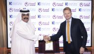 Doha Bank and the Group Securities Company  officials shake hands during launch event. 