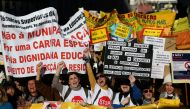 People carry banners, as school workers demonstrate for better salaries and working conditions, in Lisbon, Portugal on January 28, 2023. REUTERS/Rodrigo Antunes