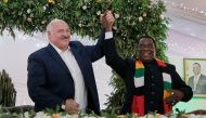 Belarus President Alexander Lukashenko (left) with Zimbabwean President Emmerson Mnangagwa upon his arrival at State House in Harare, Zimbabwe, on January 31, 2023 after a signing ceremony of bilateral agreements for economic cooperation between the two countries. (Photo by Jekesai Njikizana / AFP)