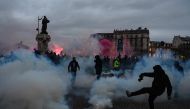 Protesters clash with police on the Place Vauban during a rally on a second day of nationwide strikes and protests over the government's proposed pension reform, in Paris on January 31, 2023. (Photo by Alain Jocard / AFP)