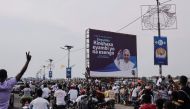 People gather on the side of the road to get a glimpse of Pope Francis (not seen) as he departs the N'djili International Airport in Kinshasa, Democratic Republic of Congo (DRC), on January 31, 2023. (Photo by Guerchom Ndebo / AFP)