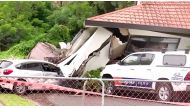 A view of a house that had collapsed on vehicles, following floods, in Auckland, New Zealand, January 30, 2023 in this screen grab obtained from video. (Newshub/via Reuters)