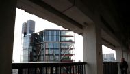 Visitor looks out from the Viewing Level towards a luxury block of flats from the Tate Modern gallery in London, Britain, February 12, 2020. REUTERS/Hannah McKay/File Photo