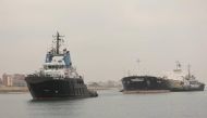 Suez Canal Authority tug boats tow the MV Glory after it recently became stuck in the waterway. File Photo / Reuters
