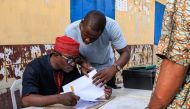 Independent National Electoral Commission (INEC) officials verify voters during a mock accreditation exercise organised by the INEC at Enitan Primary School at Surulere in Lagos, Nigeria, on February 4, 2023.  (Photo by Benson Ibeabuchi / AFP)