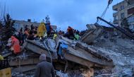 Rescue workers and volunteers search for survivors in the rubble of a collapsed building, in Sanliurfa, Turkey, on February 6, 2023, after a 7.8-magnitude earthquake struck the country's southeast. (Photo by REMI BANET / AFP)