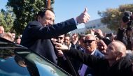 Former Cypriot foreign minister and presidential candidate Nikos Christodoulides greets supporters as he arrives to cast his vote at the Geroskypou polling centre in the western Paphos district, on February 12, 2023. (Photo by Iakovos Hatzistavrou / AFP)