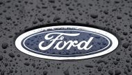 This file photograph taken on October 18, 2021, shows the Ford logo on the front of a vehicle at the company's Halewood plant in Liverpool, north-west England. - US automaker Ford said February 14, 2023, that it would cut 3,800 jobs in Europe, mostly in Britain and Germany, as competition in the electric car sector intensifies. Photo by Paul ELLIS / AFP