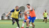 Employees of QNB taking part in a football match to mark the National Sport Day.
