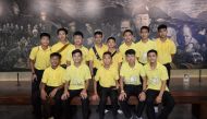 In this file photo taken on June 24, 2019 Duangpetch Promthep (front 2nd left), one of the 12 boys rescued from deep inside a Thai cave, poses for photos with other members of the 'Wild Boars' football team at the Tham Luang cave centre as they mark the first anniversary of their rescue in the Mae Sai district of Chiang Rai province. (Photo by Jittrapon Kaicome / AFP)
