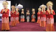 Indonesian community members take part in an activity held to promote Minang culture.