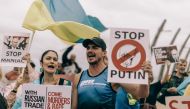 Protesters from Ukrainian Association of SA and civil society activists take part in a demonstration at the Umhlanga beach in Durban on February 18, 2023, against South Africa's joint military exercise with Russia and China along its eastern coast city of Richards Bay. (Photo by RAJESH JANTILAL / AFP)