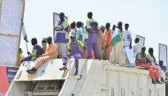 Supporters sit on a truck during an All progressives Congress (APC) rally in Maiduguri on February 18, 2023 ahead of the Nigerian presidential elections scheduled for February 25, 2023. (Photo by Audu MARTE / AFP)