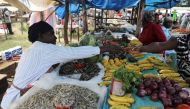 Luo shop owner Caroline Otieno sells fish that come from Lake Victoria in Kisumu county and fruits from Nandi county, at a market stall in the town of Chemase, Nandi county, Kenya August 1, 2022. REUTERS/Baz Ratner