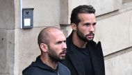 (FILES) This file photo taken on January 10, 2023 shows British-US former professional kickboxer and controversial influencer Andrew Tate (L) and his brother Tristan Tate (R) exiting a court in Bucharest, Romania. (Photo by Daniel MIHAILESCU / AFP)
