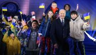 US President Joe Biden stands amid children cheering with US, Polish and Ukrainian flags after he delivered a speech in front of the Royal Warsaw Castle Gardens in Warsaw, Poland, on February 21, 2023. (Photo by Mandel Ngan / AFP)