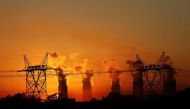 Electricity pylons in front of cooling towers at an Eskom coal-burning power station near Sasolburg in the northern Free State province.
