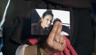 In this file photo taken on February 22, 2015 Renu, eldest sister of missing British girl Shamima Begum, holds a picture of her sister Shamima, while being interviewed by the media in central London. (Photo by Laura Lean / AFP)