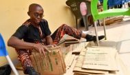 An official of Independent National Electoral Commission (INEC) prepares document ahead of the February 25 presidential election at the commission's headquarters at Awka in Anambra State, southeast Nigeria, on February 16, 2023. (Photo by Pius Utomi Ekpei / AFP)