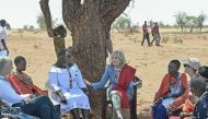 US First Lady Jill Biden interacts with women from the Maasai community at Loseti village in Kajiado county, Kenya, on February 26, 2023 where she heard about the impoverishing impact of drought to the herder community during the third day of her visit to Kenya where she toured a drought response site to highlight the impacts of drought on communities. (Photo by Tony Karumba / AFP)
