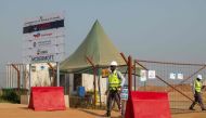 Guards work at TotalEnergies' central processing facility construction in Buliisa, Uganda on February 20, 2023. (Photo by BADRU KATUMBA / AFP)