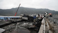 Crushed wagons are seen by the tracks after a train accident in the Valley of Tempi near Larisa, Greece on March 1, 2023. Photo by Sakis MITROLIDIS / AFP. File photo.