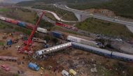 This aerial drone photograph taken on March 1, 2023, shows emergency crews examining the wreckage after a train accident in the Tempi Valley near Larissa, Greece. (Photo by STRINGER / AFP)