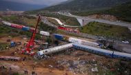 This aerial drone photograph taken on March 1, 2023, shows emergency crews searching wreckage after a train accident in the Tempi Valley near Larissa, Greece. Photo by Vasilis VERVERIDIS / Eurokinissi / AFP