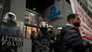 This photograph taken on March 2, 2023, shows riot police forming a security cordon in front of the Hellenic Train headquarters in Athens, during a protest, following the deadly accident near the city of Larissa on February 28 which claimed 57 lives. Photo by Louisa GOULIAMAKI / AFP