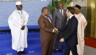 Papua New Guinea's Prime Minister James Marape (2nd L) shakes hands with French President Emmanuel Macron during the One planet summit in Libreville, on March 2, 2023. (Photo by LUDOVIC MARIN / AFP)