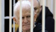 In this file photo taken on January 05, 2023 Nobel Prize winner Ales Bialiatski is seen in the defendants' cage in the courtroom at the start of the hearing in Minsk. (Photo by Vitaly PIVOVARCHIK / BELTA / AFP)
