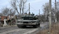 A Ukrainian tank drives through a village in Kharkiv region on March 3, 2023, amid the Russian invasion of Ukraine. (Photo by Sergey Bobok / AFP)