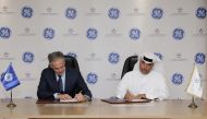 QEWC and GE officials signing the agreement.