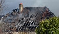 Smoke billows from the roof of a residential house that caught fire after a large explosion in Yverdon-les-Bains, western Switzerland, where 