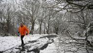 A runner braves the snow on Bidston Hill, near Birkenhead, in north west England on March 9, 2023. Photo by Paul ELLIS / AFP