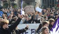 People take part in a demonstration, as part of a nationwide day of strikes and protests called by unions over the proposed pensions overhaul, in Rennes on March 11, 2023.  (Photo by Jean-Francois MONIER / AFP)
