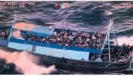 This photo grabbed from an aerial video made available by the Italian Coast Guards on March 11, 2023 shows a boat overloaded with migrants during a Coast Guards rescue operation on March 10, 2023 off the coast of Calabria, southern Italy. (Photo by Handout / GUARDIA COSTIERA / AFP) 