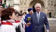 Britain's King Charles III (right) and Britain's Camilla, Queen Consort reacts as they meet with choristers following the Commonwealth Day service ceremony, at Westminster Abbey, in London, on March 13, 2023. (Photo by Jordan Pettitt / POOL / AFP)