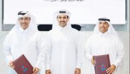 Minister of State for Energy Affairs H E Saad Sherida Al Kaabi (centre) with President of Kahramaa Eng Issa bin Hilal Al Kuwari (left) and Managing Director and General Manager of QEWC Eng Mohammed Nasser Al Hajri during the signing ceremony. 