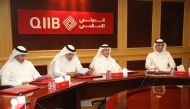QIIB Chairman Sheikh Dr Khalid bin Thani bin Abdullah Al Thani (second right) with other officials at the AGM.