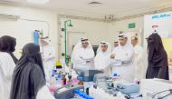 Minister of Environment and Climate Change H E Sheikh Dr. Faleh bin Nasser bin Ahmed Al Thani interacting with officials during a visit to environmental laboratories.