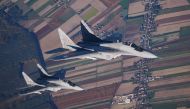 This file photo taken on October 12, 2022 shows two MiG 29 fighter jets taking part in the NATO Air Shielding exercise near the air base in Lask, central Poland. (Photo by RADOSLAW JOZWIAK / AFP)
